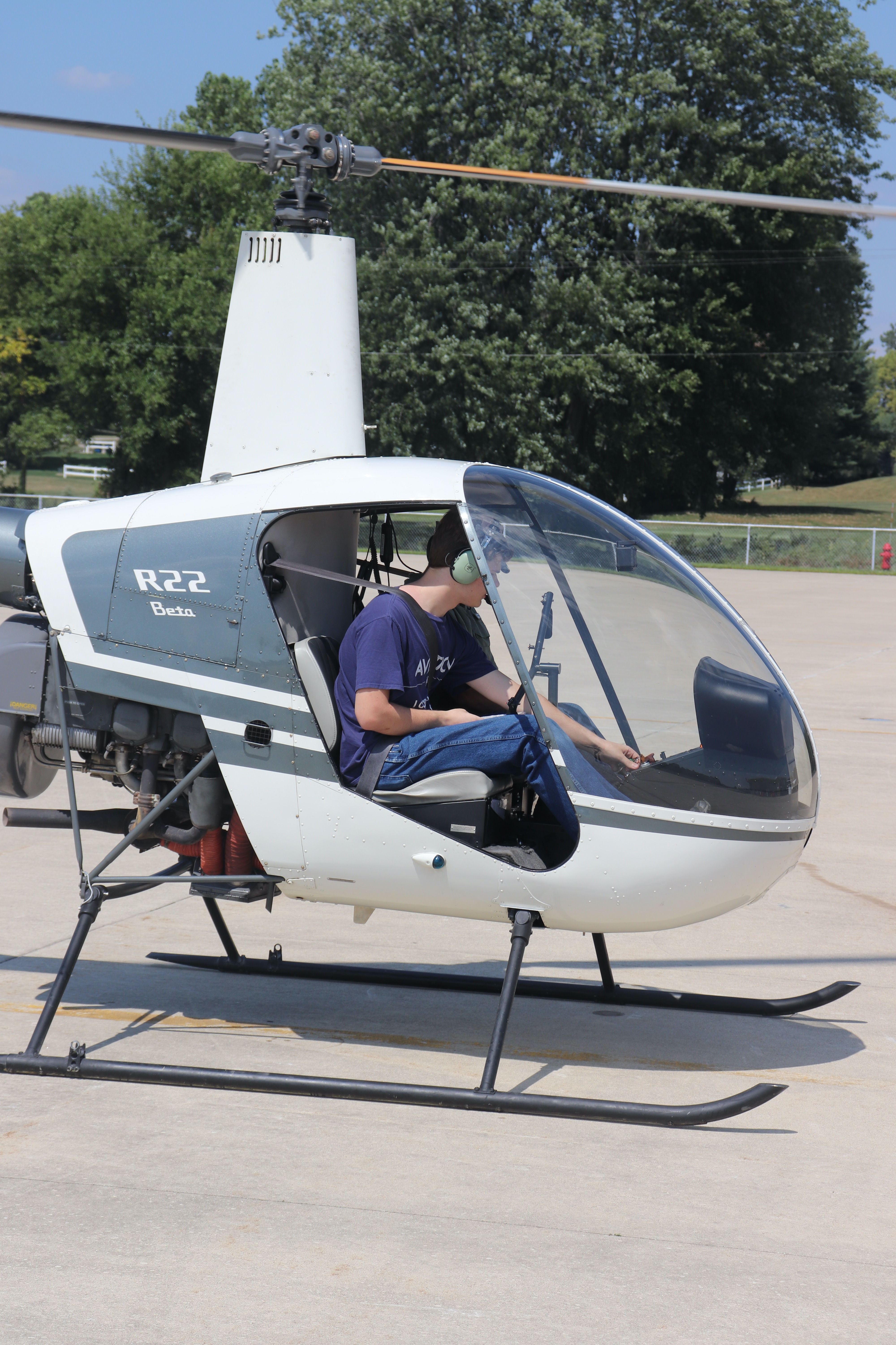 Luke Arthur sitting in a Robinson R-22 during his helicopter flight lessons